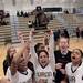 Huron River Rats crowd around Bianca Williams as she hoists the MHSAA Girls Basketball trophy into the air after their 47-36 win against the Brighton Bulldogs at Skyline High School on Friday, March 2. Chris Asadian | AnnArbor.com 